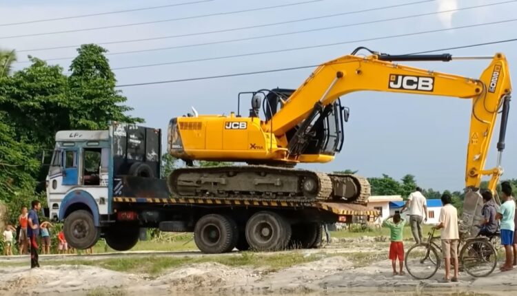 Experienced Excavator Operator Loading And Unloading Excavator